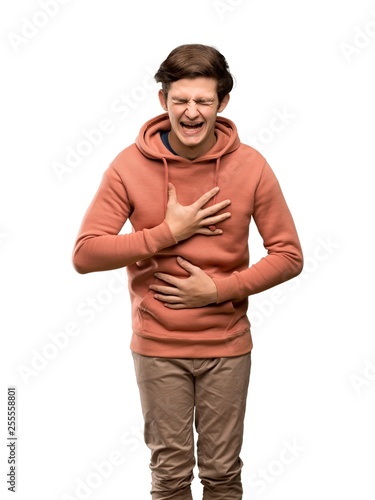 Teenager man with sweatshirt smiling a lot over isolated white background