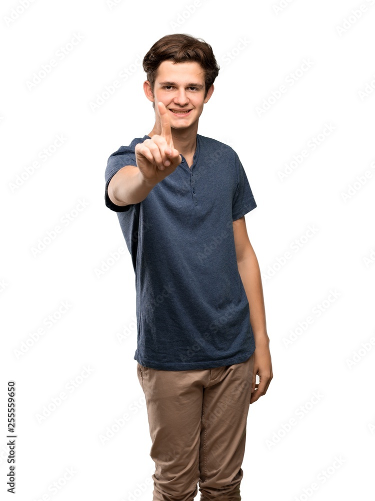 Teenager man showing and lifting a finger over isolated white background Teenager man showing and lifting a finger over isolated white background