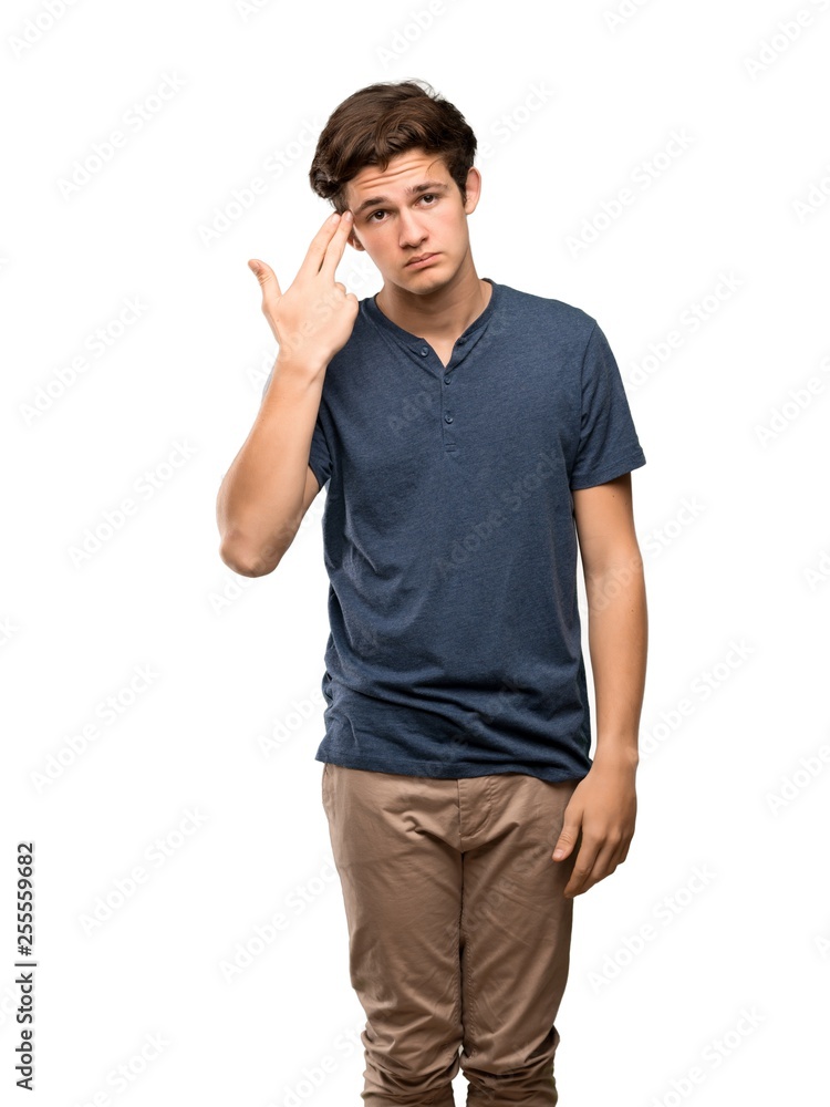 Teenager man with problems making suicide gesture over isolated white background Teenager man with problems making suicide gesture over isolated white background