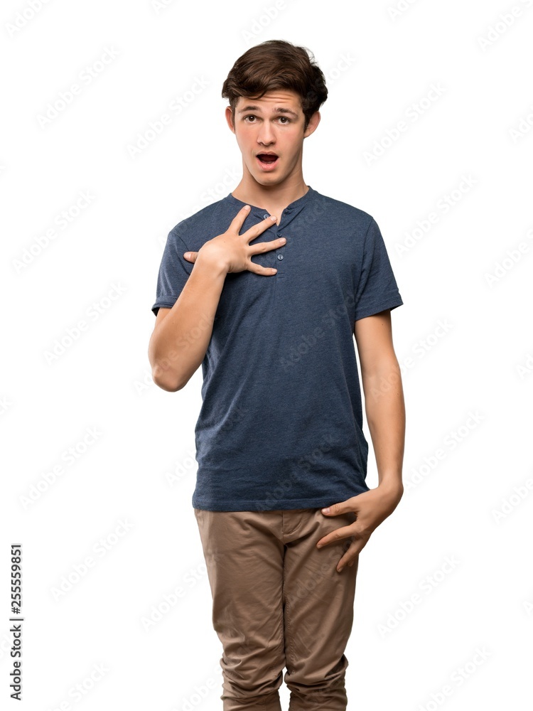 Teenager man surprised and shocked while looking right over isolated white background Teenager man surprised and shocked while looking right over isolated white background