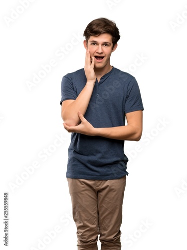 Teenager man surprised and shocked while looking right over isolated white background