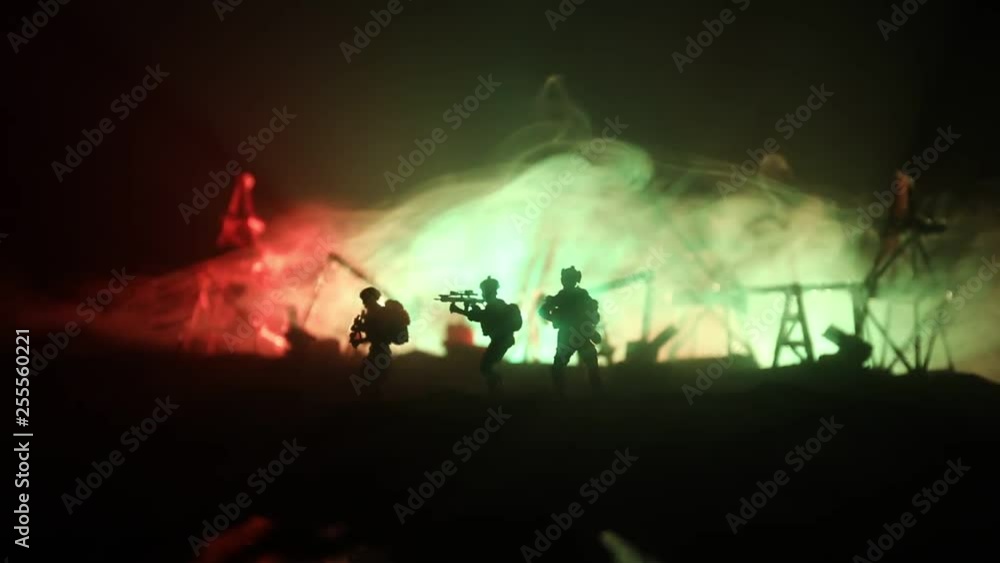 Artwork decoration. Oil war concept. Military silhouettes at oilfield with pumps and rigs. Misty colorful sky background. Armored vehicles fighting scene. Selective focus Artwork decoration. Oil war concept. Military silhouettes at oilfield with pumps and rigs. Misty colorful sky background. Armored vehicles fighting scene. Selective focus
