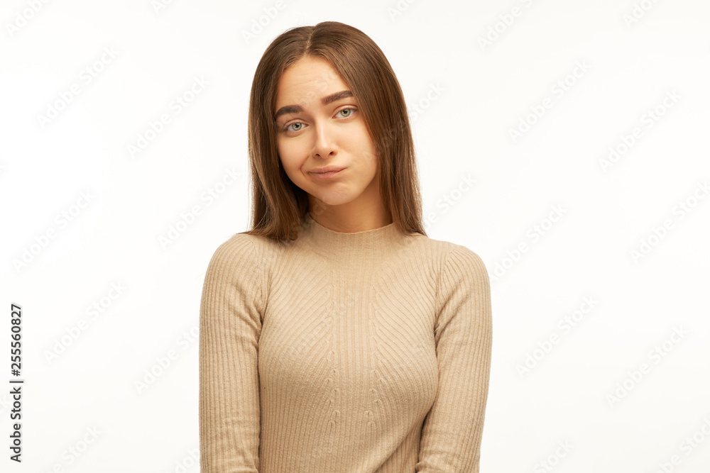 Cute young female dressed casually pursuing lips, absorbed in thinking, trying to find right solution while dealing with some problem, having concentrated indecisive look Cute young female dressed casually pursuing lips, absorbed in thinking, trying to find right solution while dealing with some problem, having concentrated indecisive look