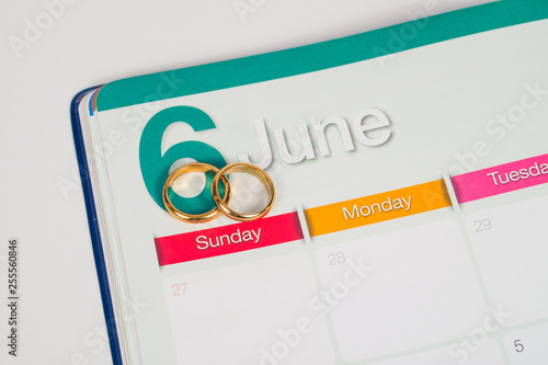 Gold Wedding ring on calendar planning or office tool.