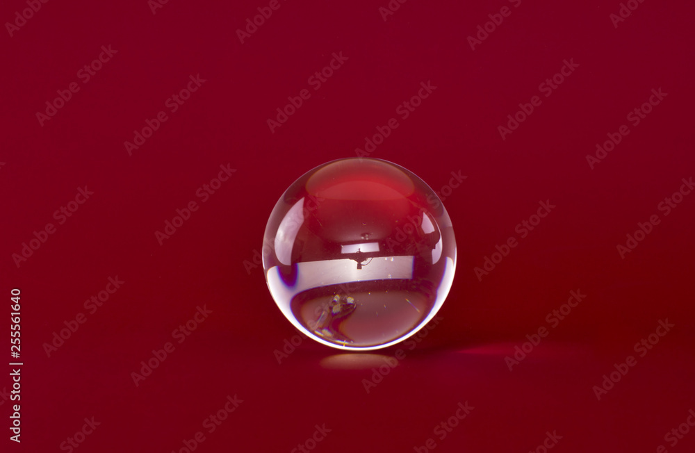 magic glass ball isolated on red background magic glass ball isolated on red background