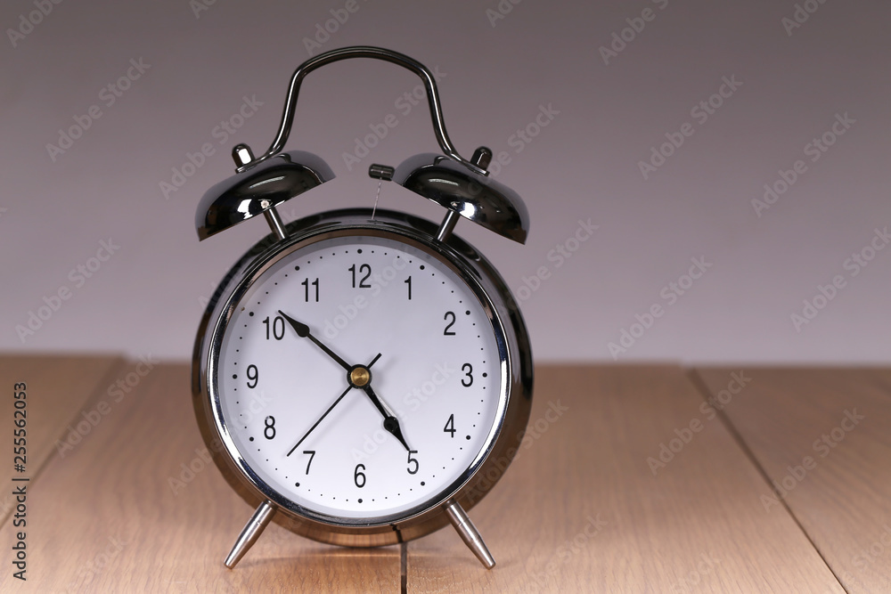 The old alarm clock on a light background The old alarm clock on a light background