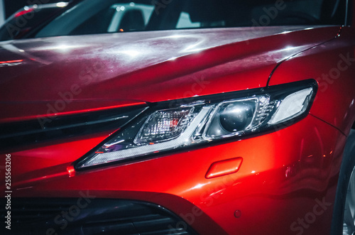modern ice headlight red car close up