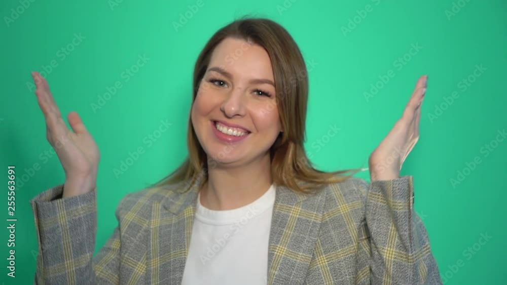 Smiling woman sends air kiss at the camera over green background chromakey Smiling woman sends air kiss at the camera over green background chromakey