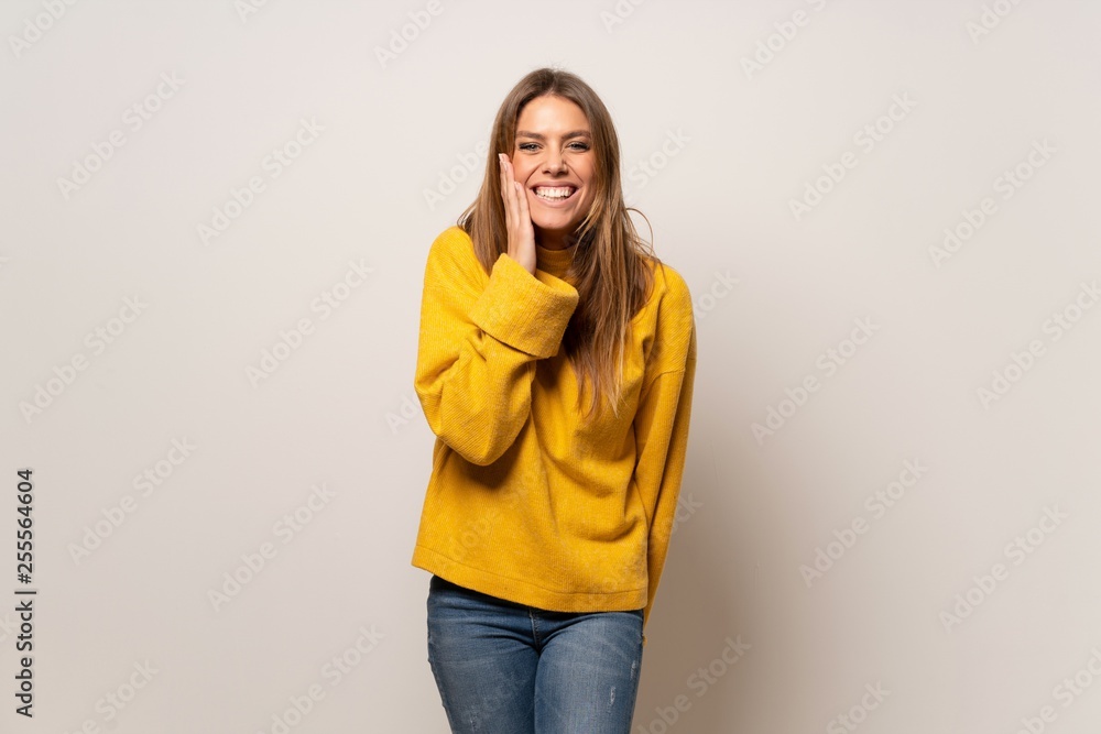 Woman with yellow sweater over isolated wall with surprise and shocked facial expression Woman with yellow sweater over isolated wall with surprise and shocked facial expression