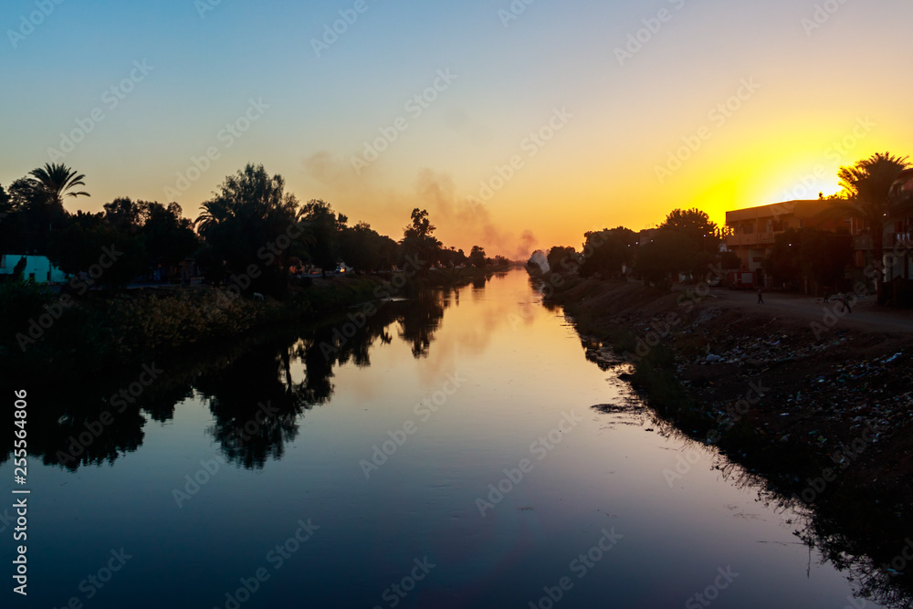View of irrigation canal at sunset in Egypt