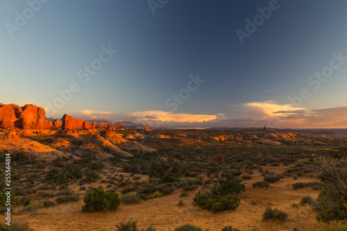 Breathtaking panoramic view of Arches National Park, Utah, at sunset, with famous red rocks in the background