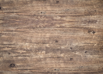 Wood texture background. Rough weathered vintage table with cracks. Brown rustic board for backdrop. Surface of old knotted wood with nature color and pattern.