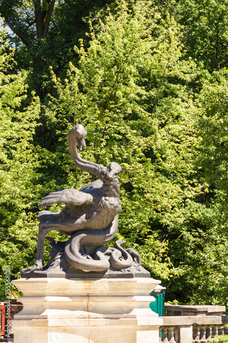 Sculpture of famous French nineteenth sculptor  Emmanuel Fremiet. Snake attacking a ostrich in Polish park Swierklaniec. photo