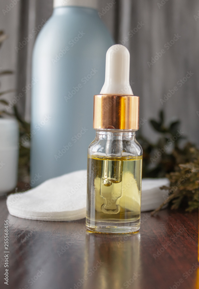 Essential oil in a bottle of cosmetic skin care products. Homemade medicine and product concept.