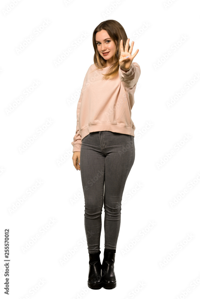 A full-length shot of a Teenager girl with pink sweater happy and counting four with fingers over isolated white background A full-length shot of a Teenager girl with pink sweater happy and counting four with fingers over isolated white background