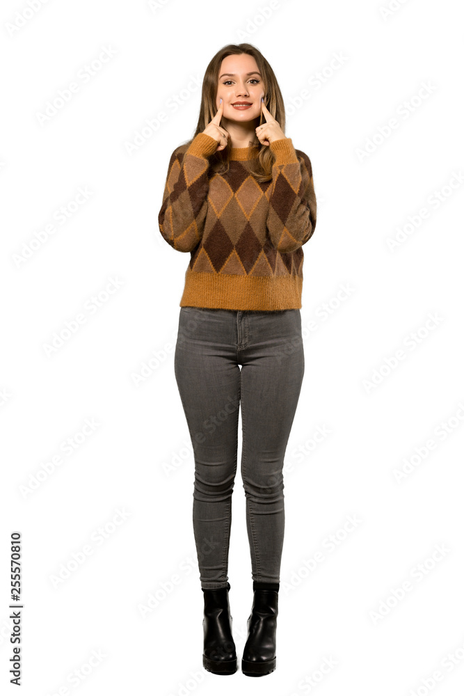 Fototapeta premium A full-length shot of a Teenager girl with brown sweater smiling with a happy and pleasant expression over isolated white background