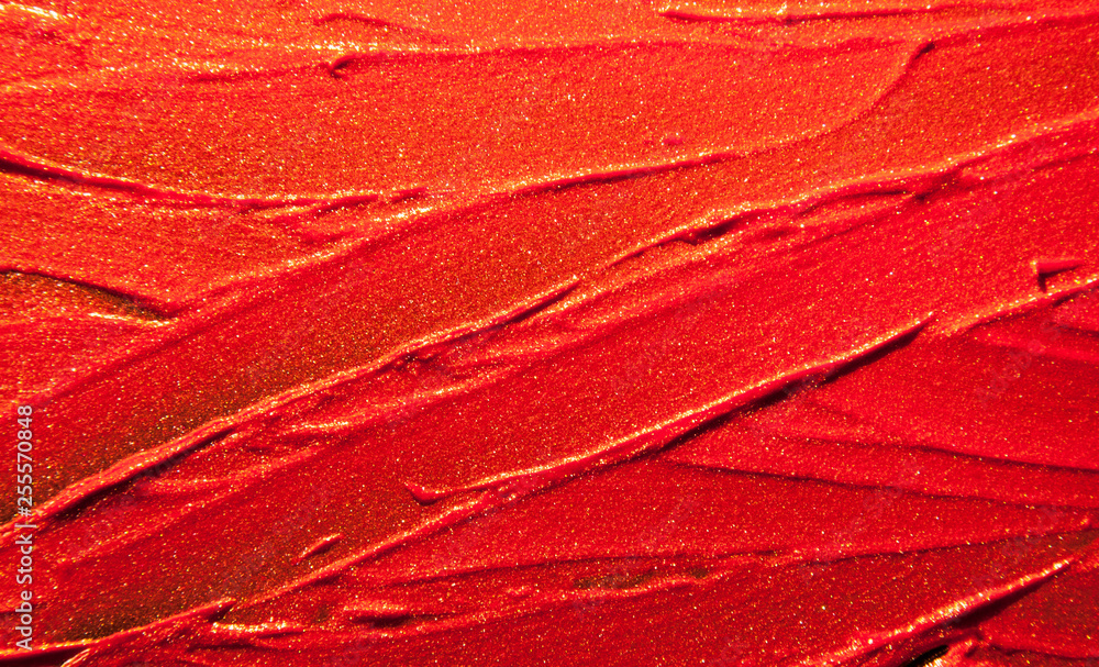 Fototapeta premium Glitter lipstick smeard background classic red