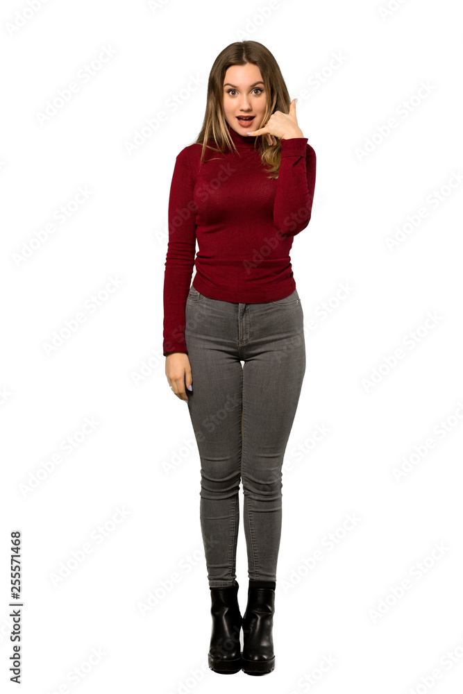A full-length shot of a Teenager girl with turtleneck making phone gesture. Call me back sign over isolated white background A full-length shot of a Teenager girl with turtleneck making phone gesture. Call me back sign over isolated white background
