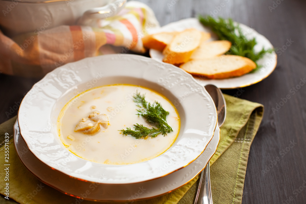 Creamy fish soup with salmon, potatoes and dill