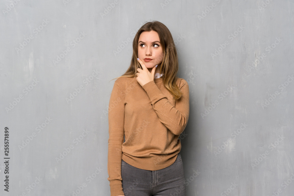 Teenager girl over textured wall thinking Teenager girl over textured wall thinking