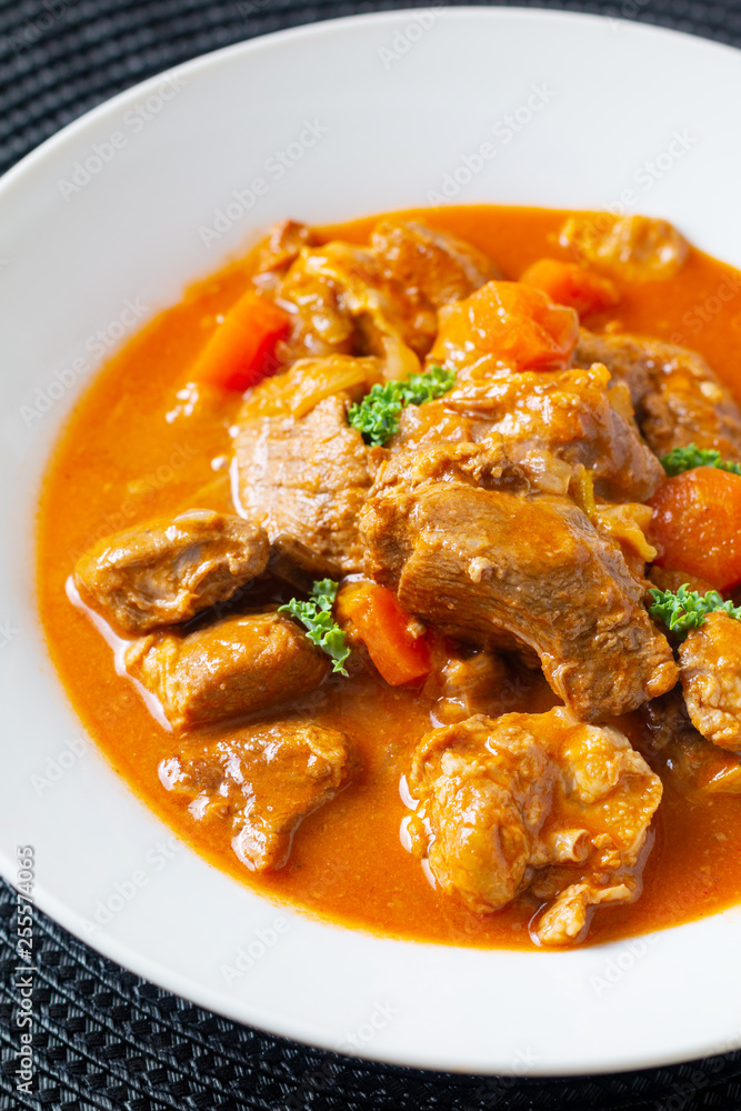Food concept french classic veal stew marengo de veau in white ceramic plate with copy space Food concept french classic veal stew marengo de veau in white ceramic plate with copy space