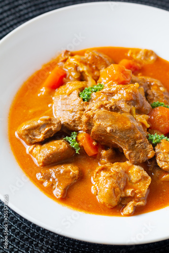 Food concept french classic veal stew marengo de veau in white ceramic plate with copy space