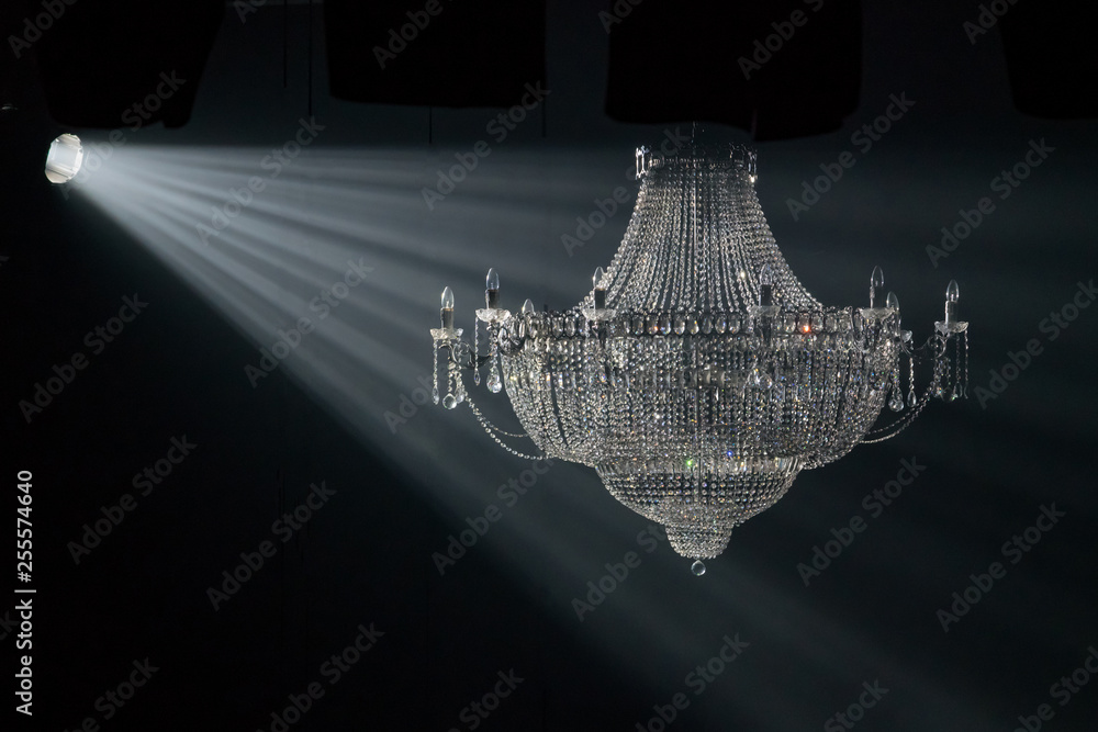 Beautiful crystal chandelier in the rays of light