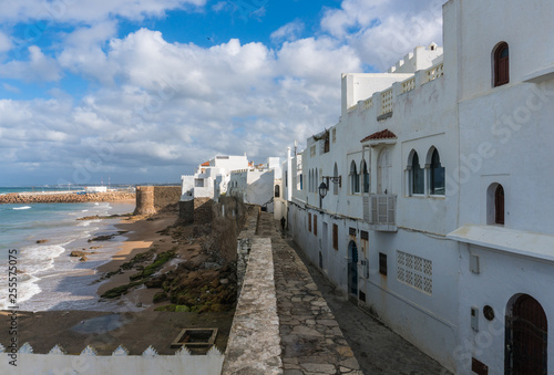 Landmark of Asilah - Atlantic Ocean Surf and Old City Wall with white houses on Seaside. Asilah, Morocco