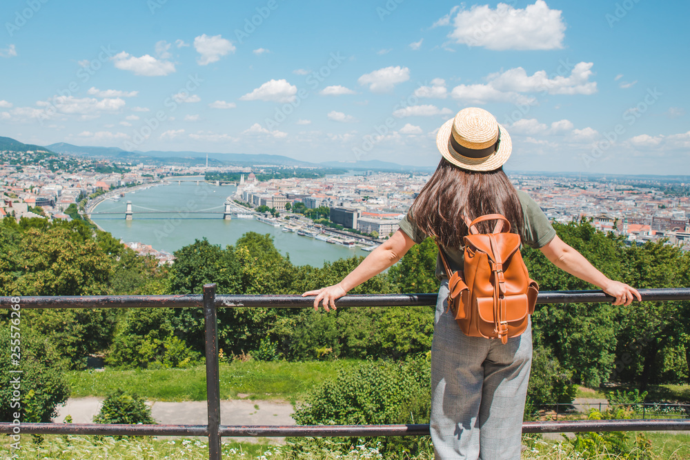 young stylish woman looking at panoramic view of budapest city. summer travel concept
