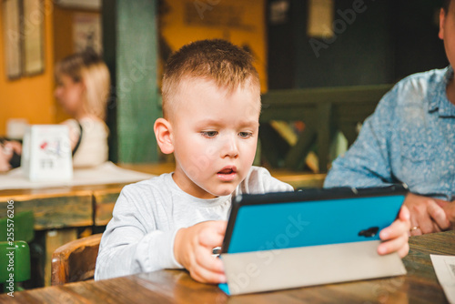 little boy sitting with tablet. modern lifestyle