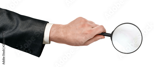 Crop close-up of man's hand holding magnifying glass isolated on white background.