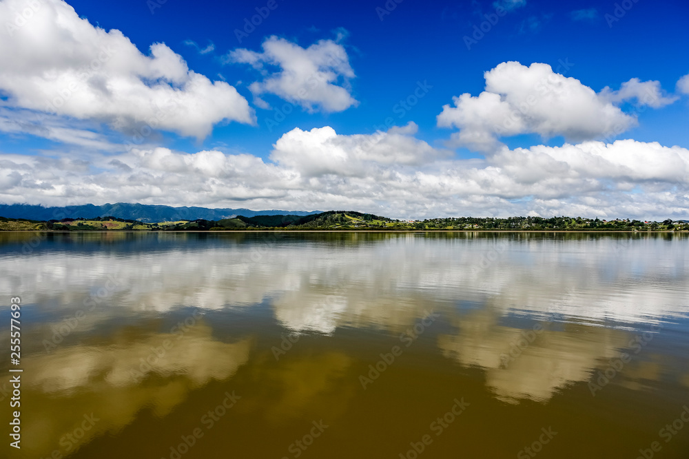 River Refelction of clouds and blue sky noertland near Omapere New Zealand.