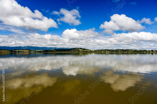 River Refelction of clouds and blue sky noertland near Omapere New Zealand.