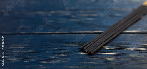 sandalwood sticks on a black wooden table. Traditional Asian culture. Aromatherapy photo