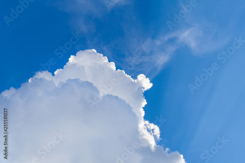 White cumulus fluffy clouds in bright blue sky