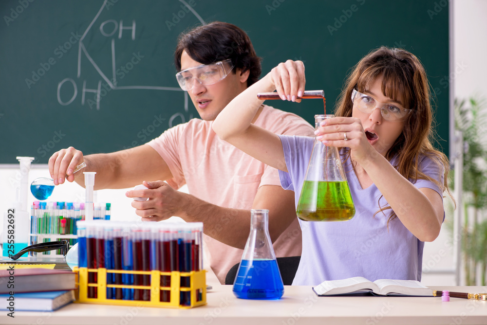 Two chemists students in classroom Two chemists students in classroom