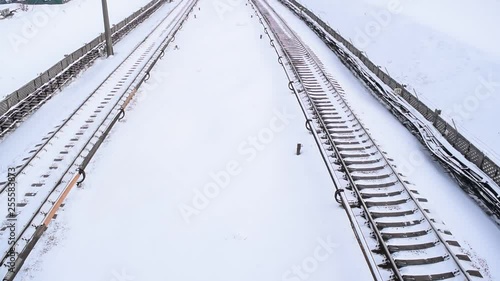 Top view of the rails and subway train in the city in winter. photo