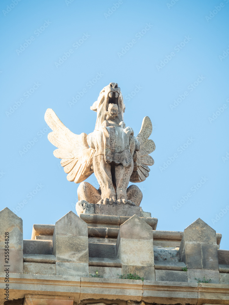 Statue of monster above the Agencia Estatal de Administración Tributaria (AEAT), commonly known as Agencia Tributaria is the revenue service of the Kingdom of Spain. Statue of monster above the Agencia Estatal de Administración Tributaria (AEAT), commonly known as Agencia Tributaria is the revenue service of the Kingdom of Spain.