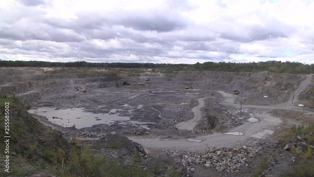 Quarry truck on open pit mining. Granite quarry. Working mining machines. Mining industry. Open-cast quarry, limestone mining. Cloudy windy day. Quarry truck on open pit mining. Granite quarry. Working mining machines. Mining industry. Open-cast quarry, limestone mining. Cloudy windy day.