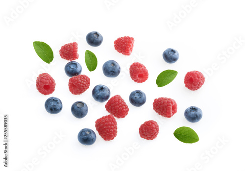 Raspberries and blueberries white background top view