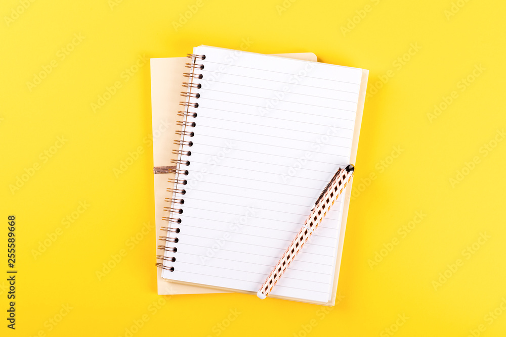 Notebook, and pen on a bright yellow background.Accessories office concept.Business Idea. Time to school.Top View.Flat Lay. Copy space for Text. Notebook, and pen on a bright yellow background.Accessories office concept.Business Idea. Time to school.Top View.Flat Lay. Copy space for Text.