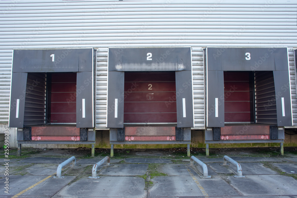 Three loading docks  with red doors of a warehouse