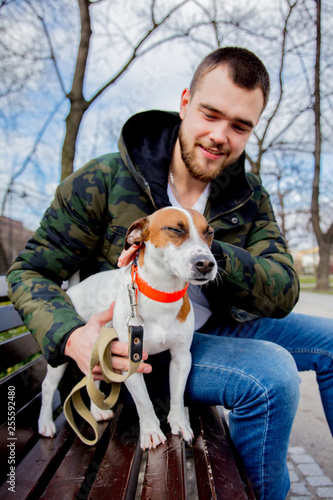 Young man with his dog, Jack Russell Terrier, © Masson
