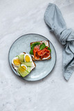 Smorrebrod - danish open sandwich with fish, vegetables, cheese on marble background. Top view with copy space