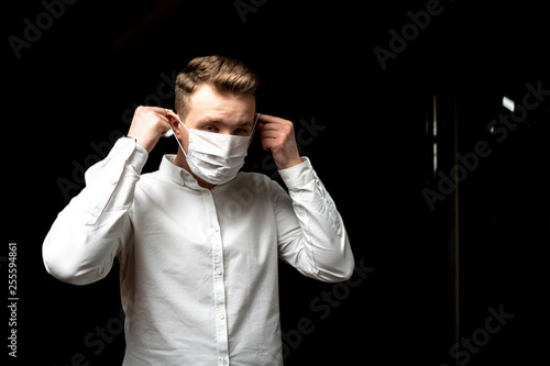 sick businessman in his office wear protective mask. illness concept