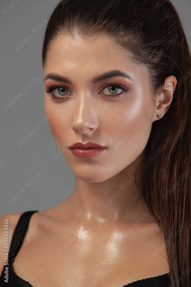 Fototapeta premium Closeup portrait of beautiful young woman with clean and fresh skin. Nude makeup. Concept for cosmetology ads with copy space, beauty magazine and spa.