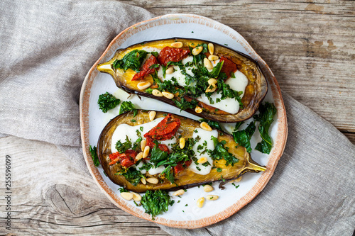 Roast aubergine with goat cheese, sun dried tomatoes, crispy kale and pine nuts