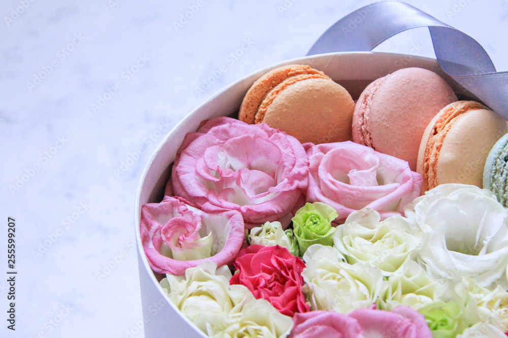 round Box with flowers and almond cookies on marble background round Box with flowers and almond cookies on marble background