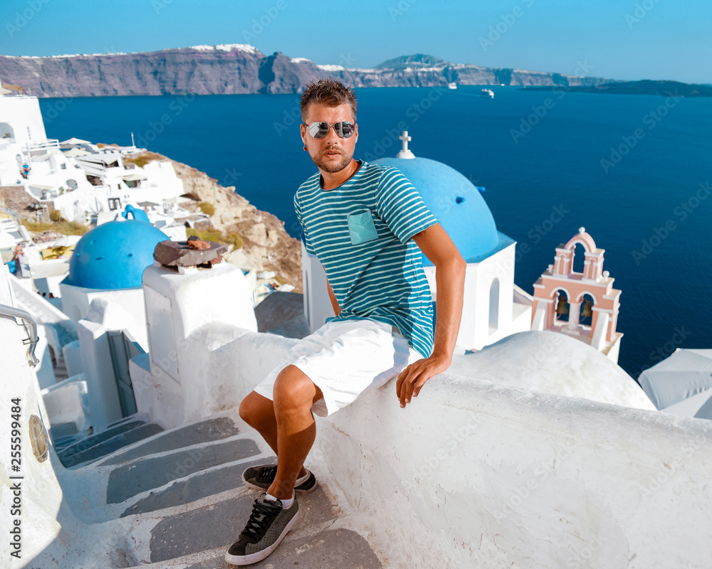Santorini greece, young middle age men on vacation in Santorini Greece, man at the village of