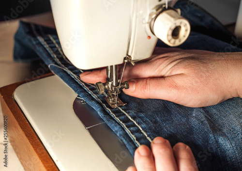 The sewing process. Sewing female hands. sewing industry workshop